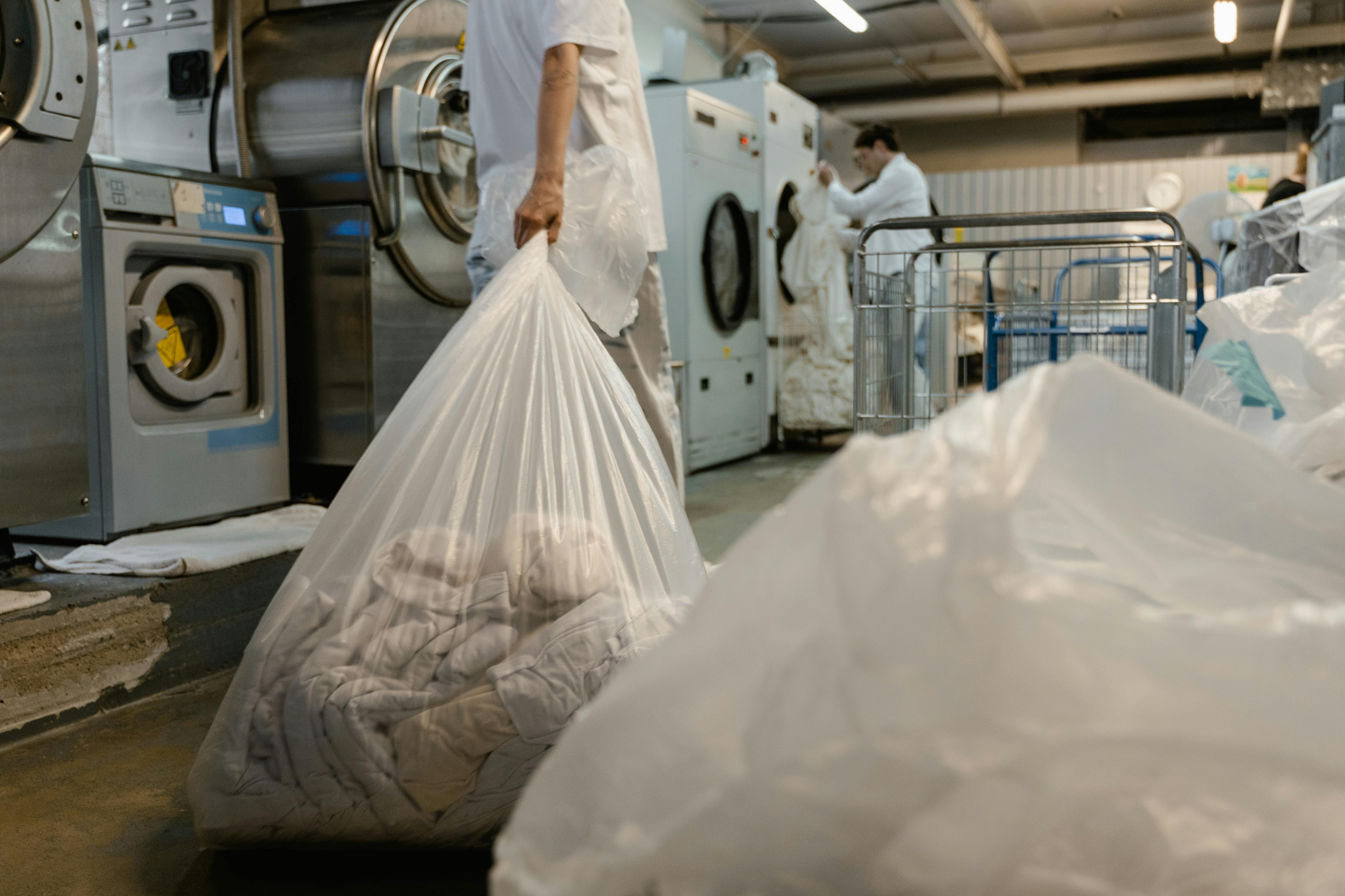 A Person Holding a Plastic Bag with Laundry